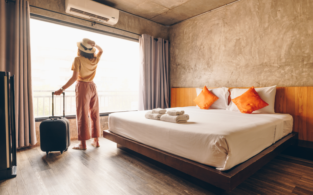 Guest standing in her hotel room with luggage